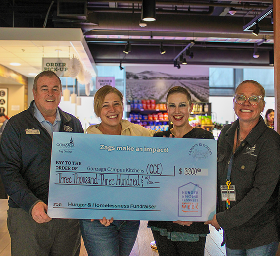 A woman stands with her arms crossed next to a window